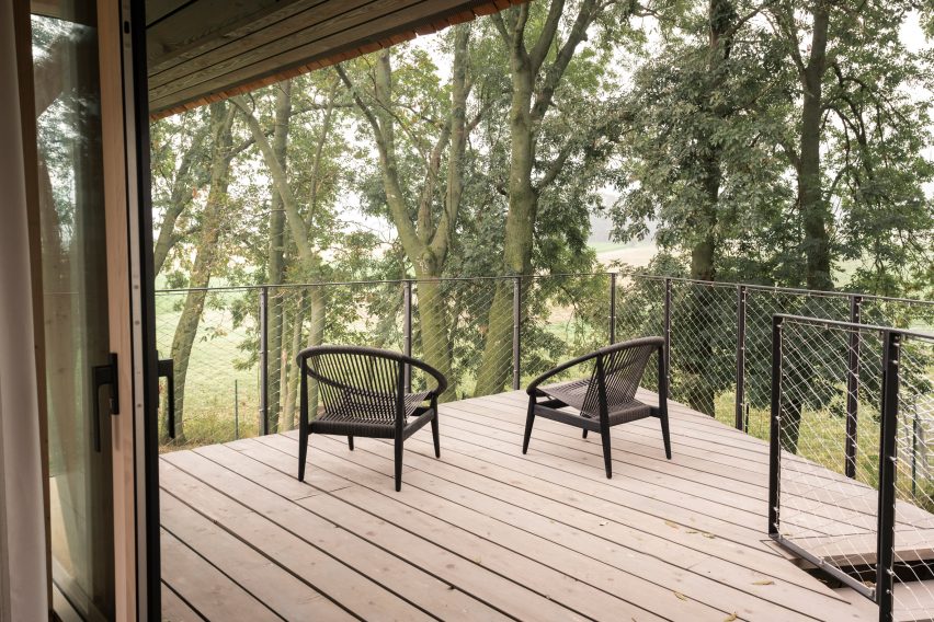 Deck of glass micro house on stilts by Jan Tyrpekl in Austria