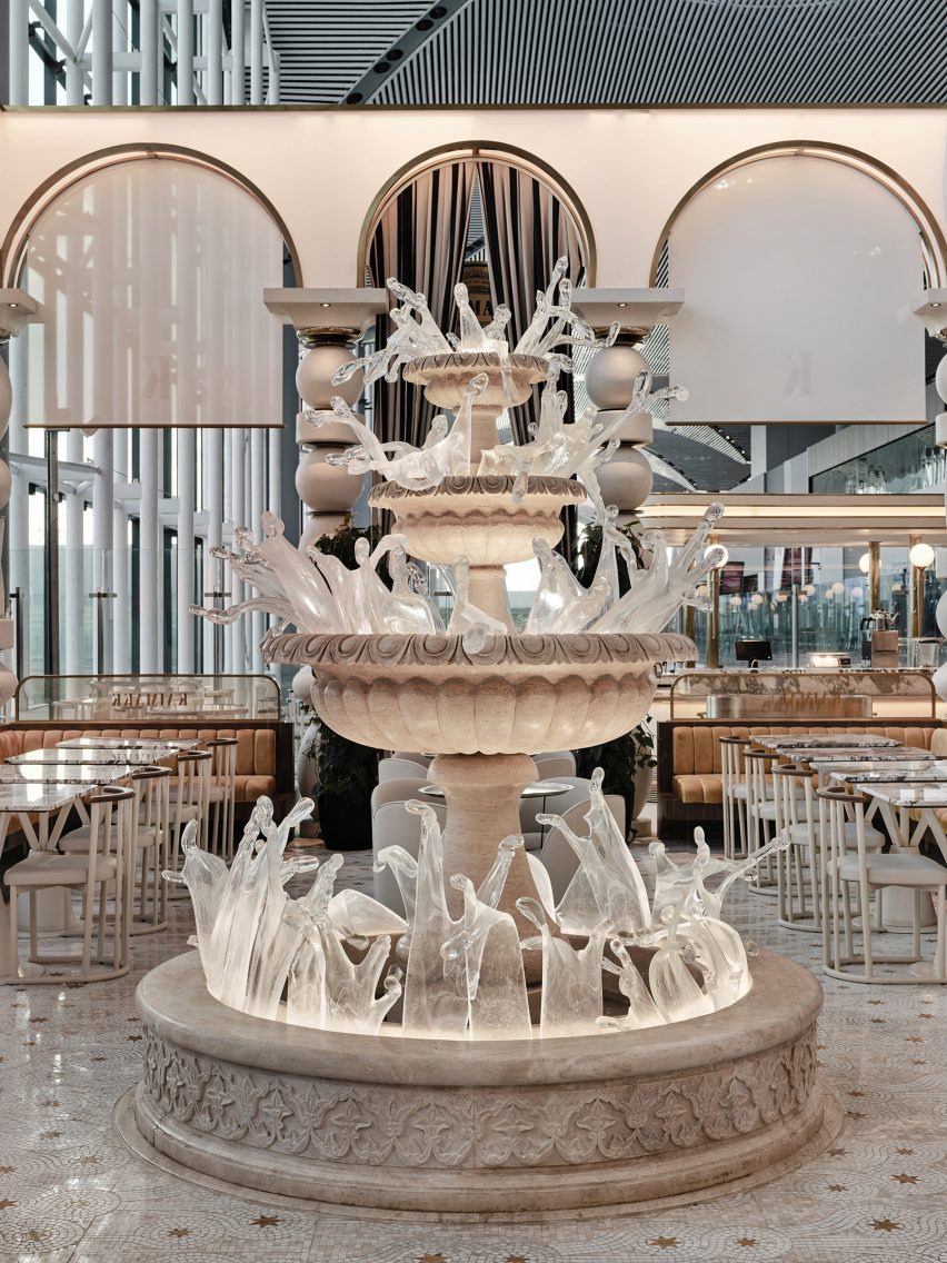 Four-tiered stone and glass fountain Istanbul Airport dining area