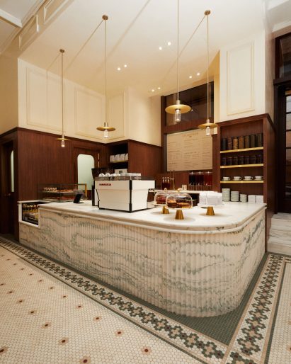 A cafe and flower shop featuring mosaic floors and a fluted marble service counter