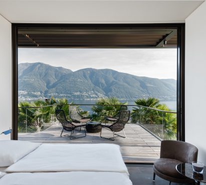 Bedroom and terrace of a cantilevered house by Küchel Architects in Switzerland