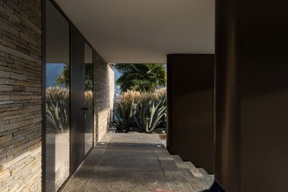 Entrance of rectilinear cantilevered house by Küchel Architects in Switzerland