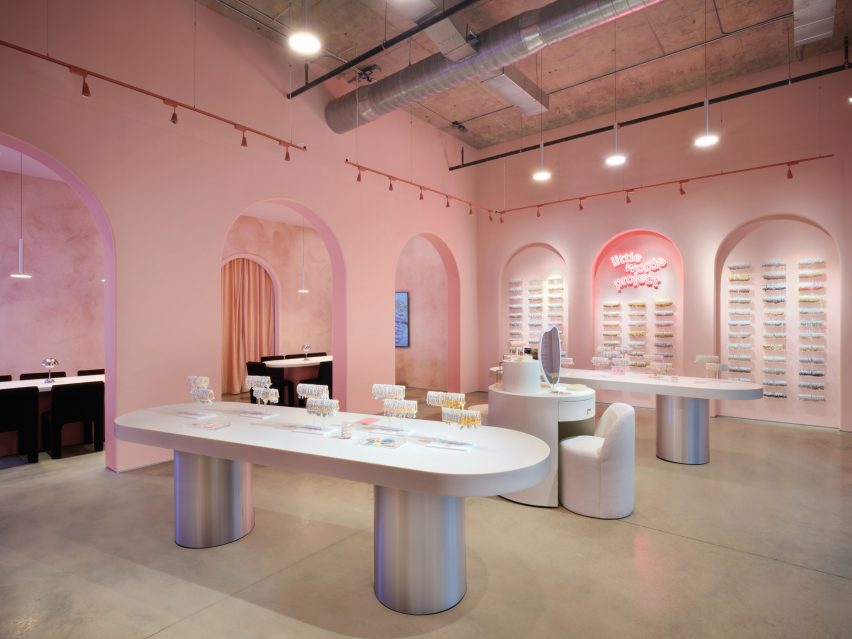 A retail store with silver with long white tables