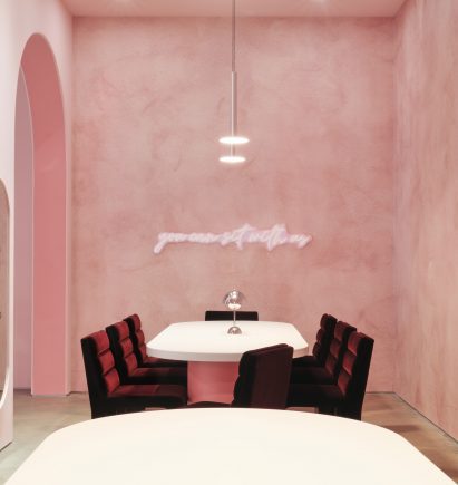 Space with velvet chairs and textured wallpaper