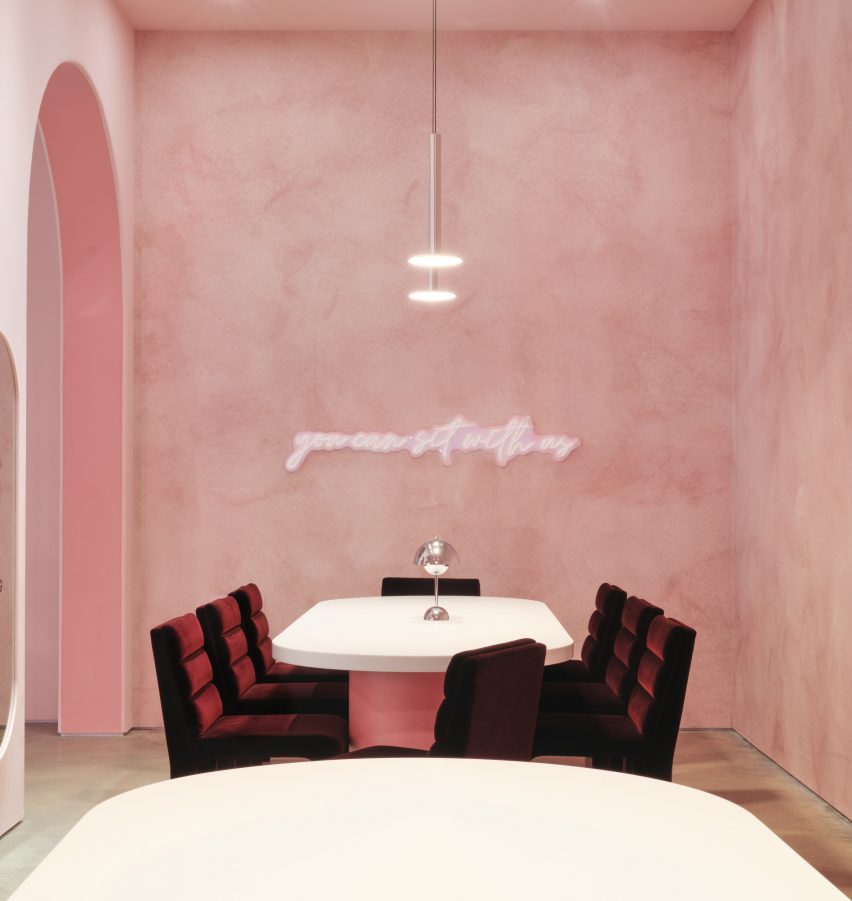 Space with velvet chairs and textured wallpaper
