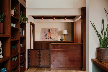 Hotel reception counter clad in oxblood-coloured tiles