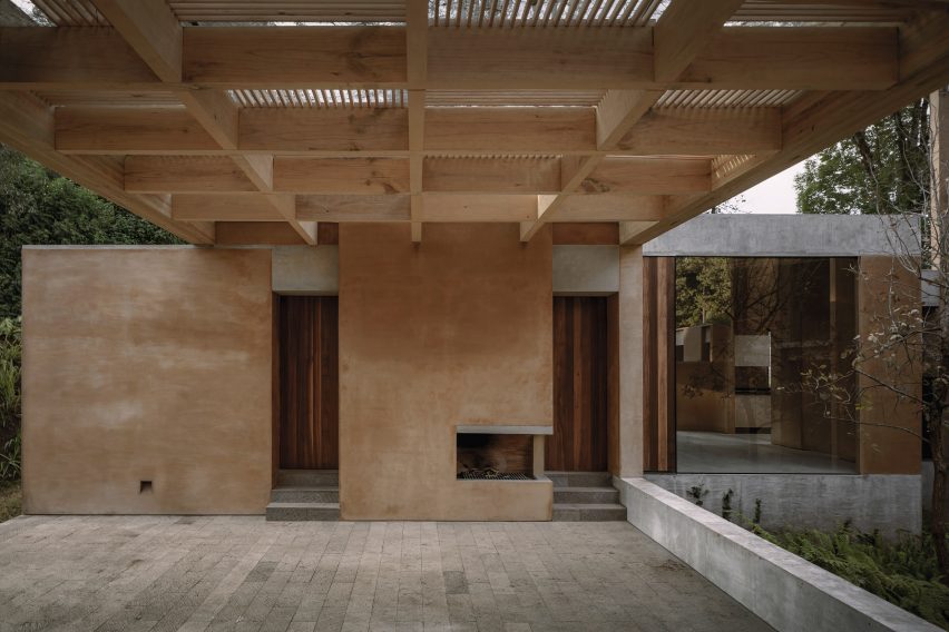 A wooden pergola above porch area
