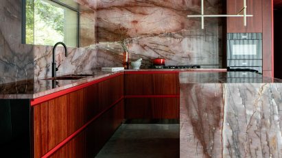 Kingston Lafferty Design includes “sensual” red quartzite kitchen in townhouse renovation