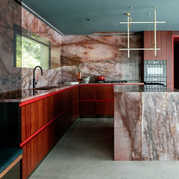 Kingston Lafferty Design includes “sensual” red quartzite kitchen in townhouse renovation