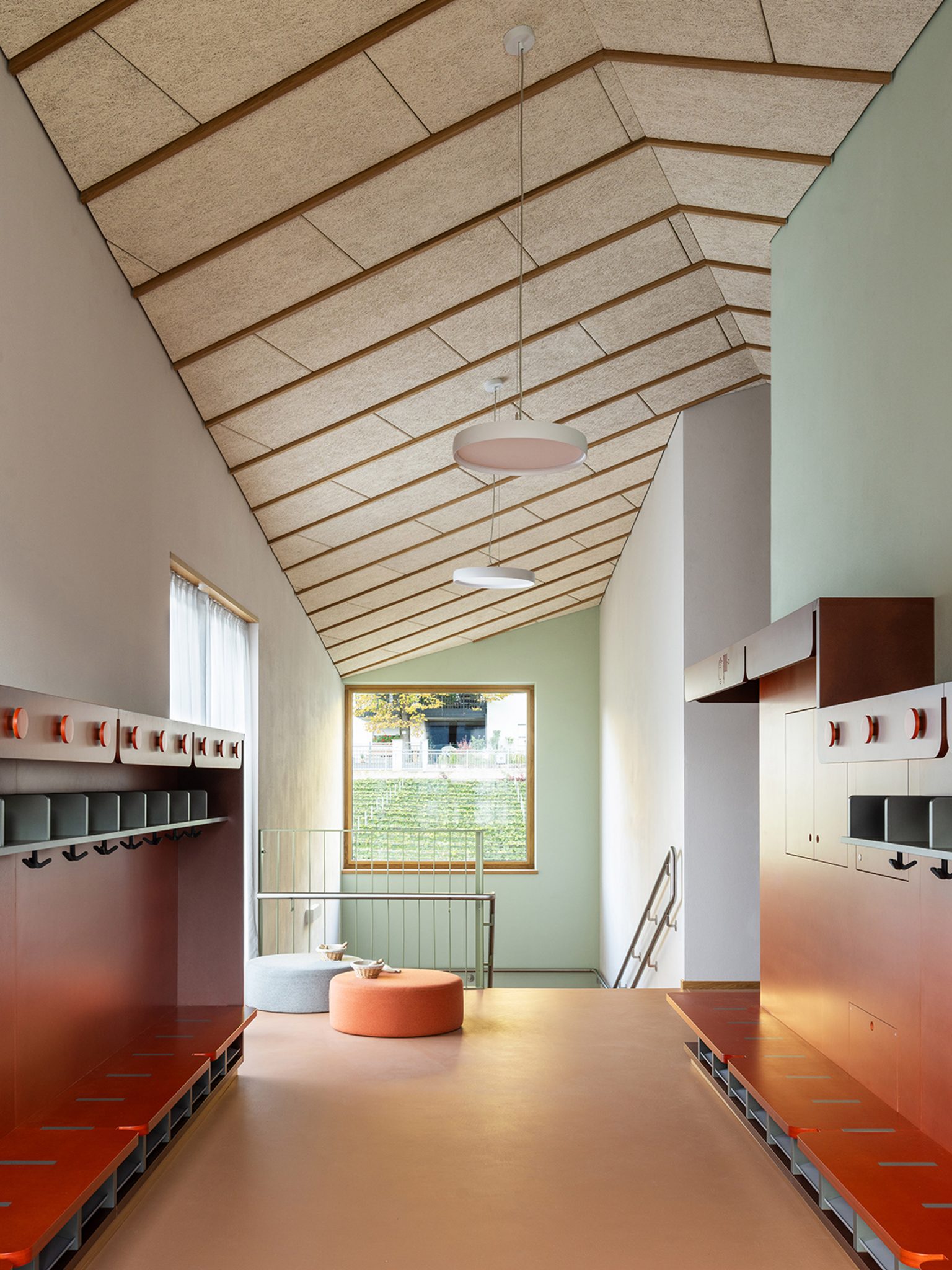 Interior of Tartan School featuring red-brick resin flooring, wooden ceilings and MDF furniture