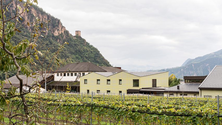 MoDus Architects' school extension is positioned next to a traditional Italian vineyard