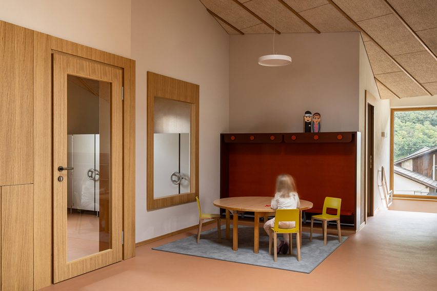 Kindergarten room with a girl sitting at the table