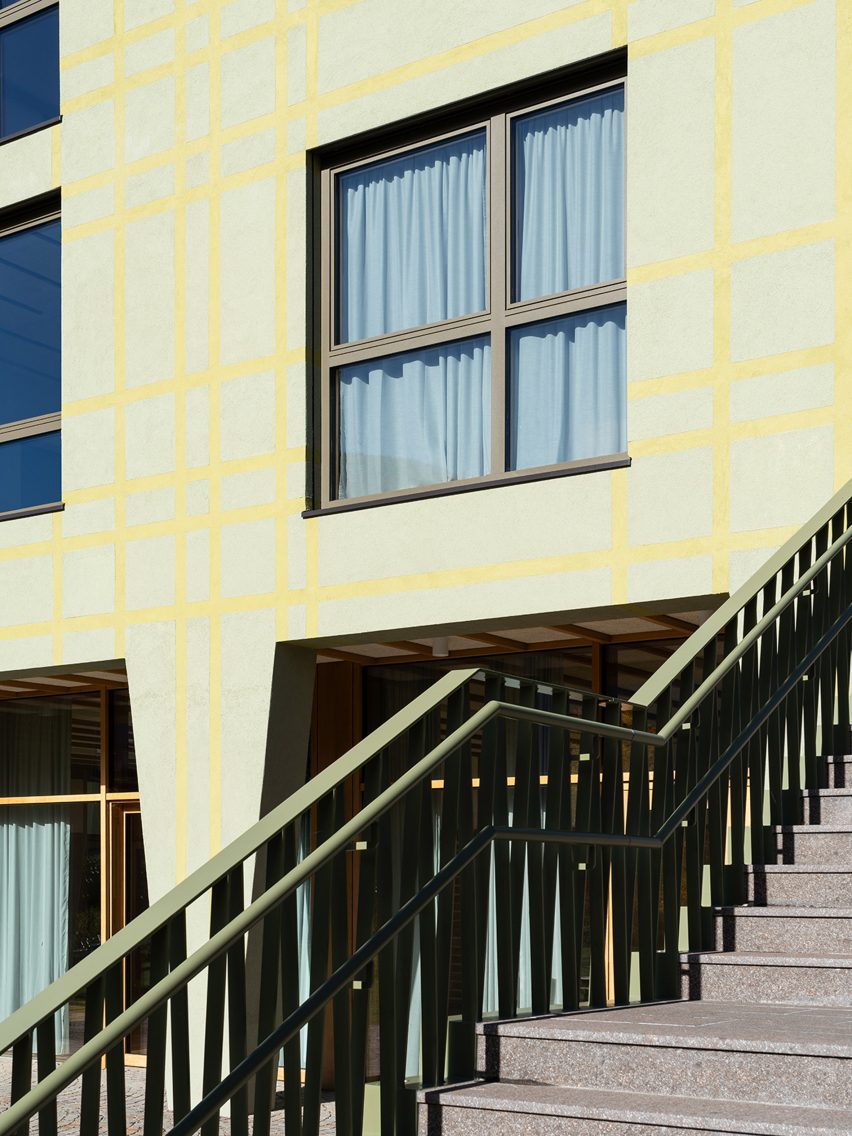 Tartan-patterned facade of educational extension