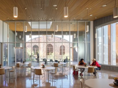 Stone building framed through floor to ceiling glass
