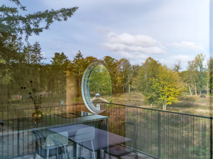 Window of timber-cladded holiday home in the woods