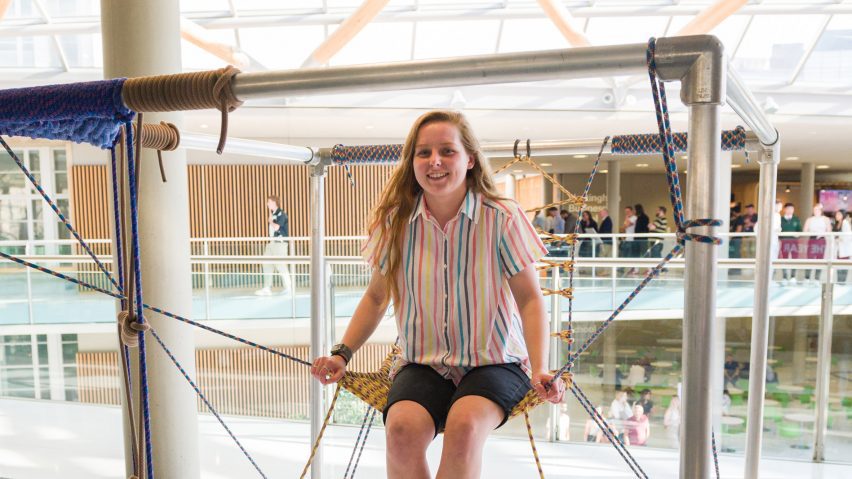 girl sitting on swing-like installation