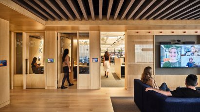 Wood-lined workspace with private booths and open Zoom areas