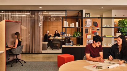 Workspace with glass meeting room, privacy booth and shelving for pin-ups