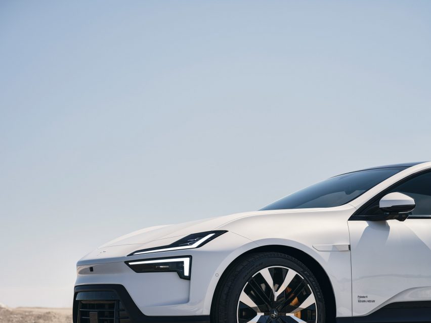 Image of the front of a white car with sleek headlights in the shape of two parallel blades