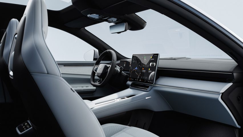 Image of a car interior with a large information display and a knit textile dashboard