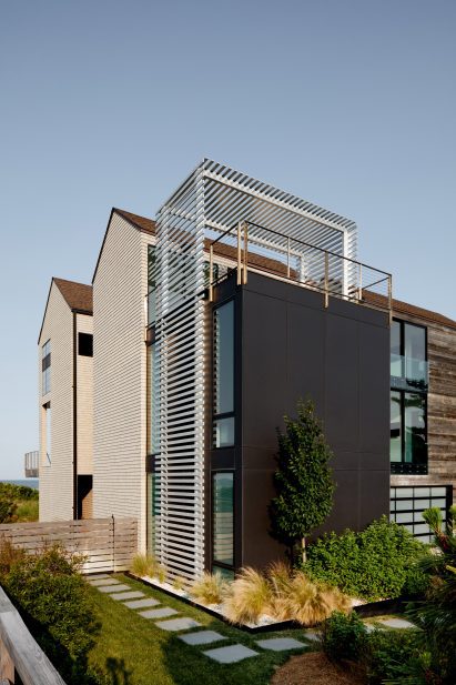 Gabled house with attached metal volume