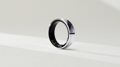 Photo of a chunky but smooth, simple silver ring with the subtle outlines of some sensors visible on the inner ring