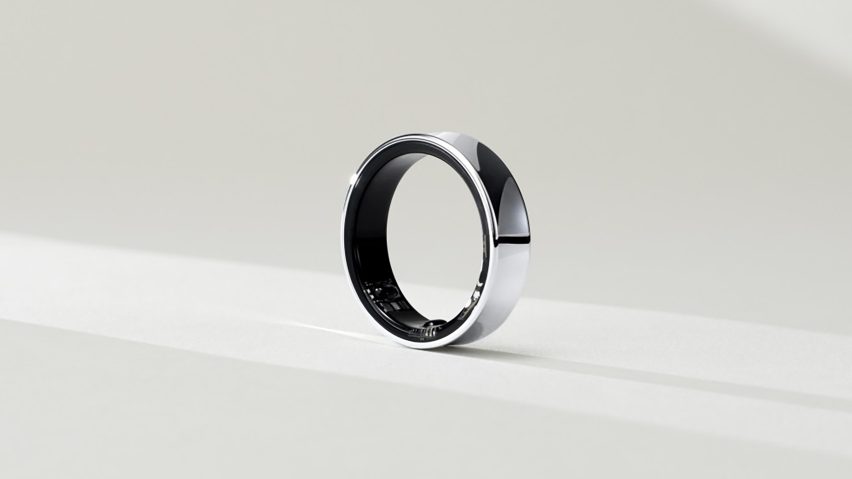Photo of a chunky but smooth, simple silver ring with the subtle outlines of some sensors visible on the inner ring