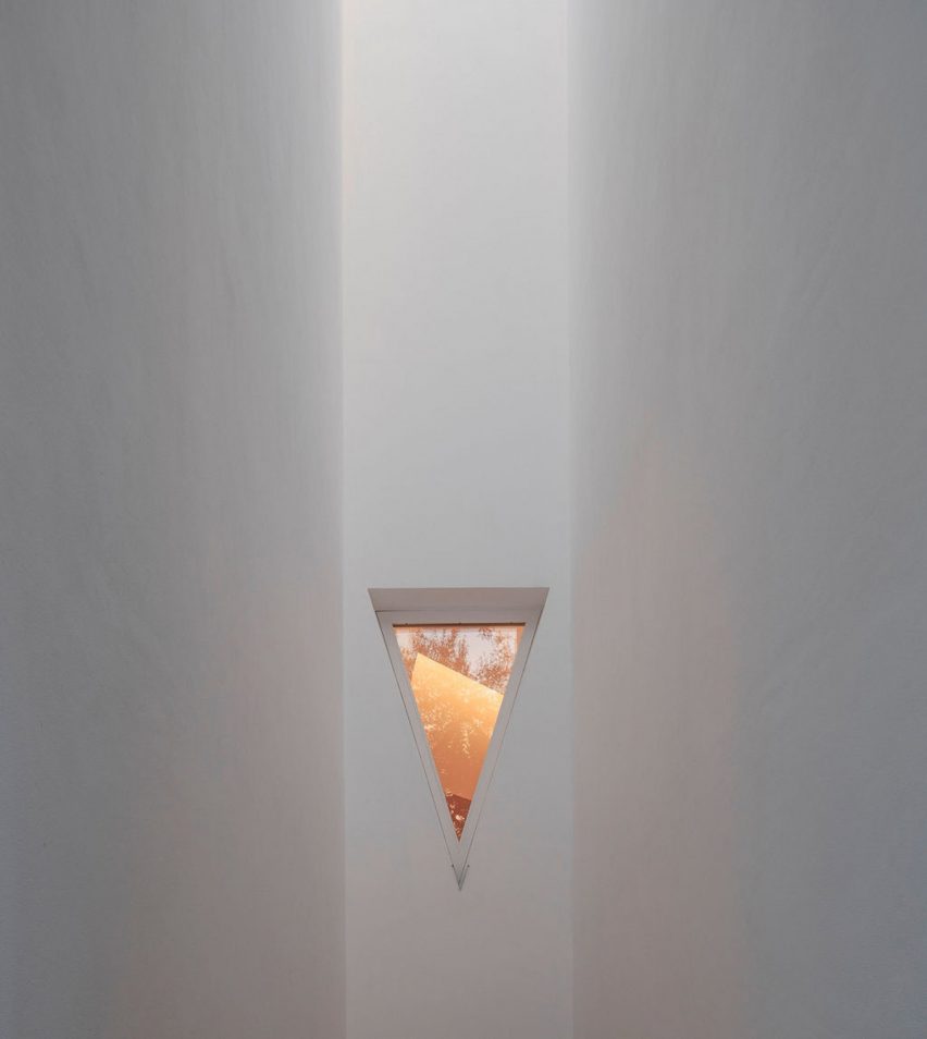 Triangular window on a white wall