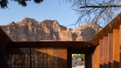 Photo of the internal courtyard of Design Space AlUla in Saudi Arabia showing desert hills rising in the background beyond the building's roofline