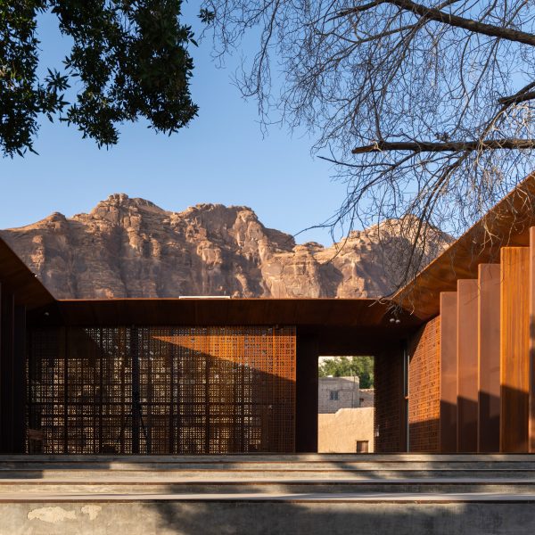Photo of the internal courtyard of Design Space AlUla in Saudi Arabia showing desert hills rising in the background beyond the building's roofline