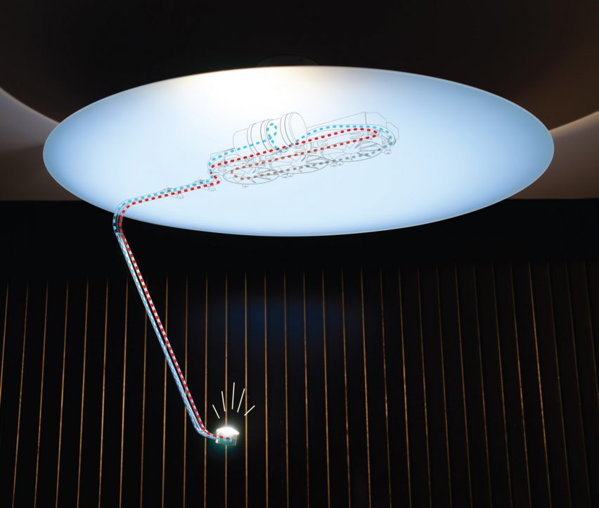 Photo of the Sunday Light with a diagram of the cooling system overlaid on top, showing one blue line going down to the LED and one red line coming up in a loop