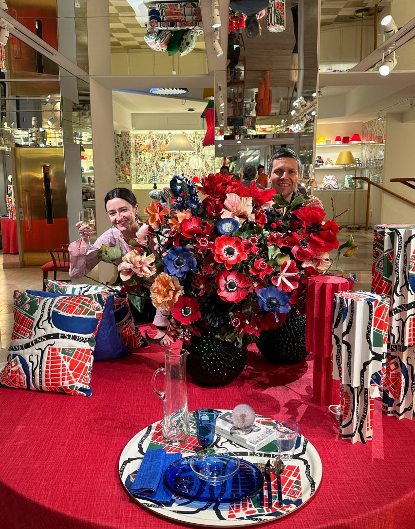 Max and Jane behind a bouquet of flowers