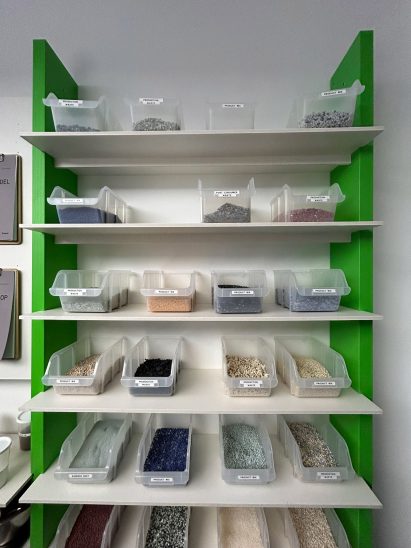 Different boxes on shelves holding different coloured post consumer waste