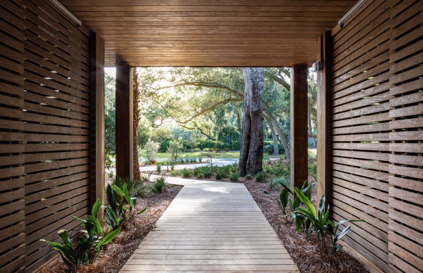 A walkway concealed under a wooden tunnel