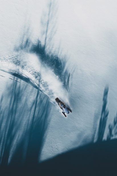 Render of person driving a snowmobile from above