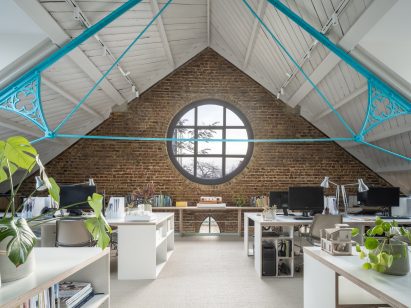First floor workspace with rose window in Addison Studios by Tigg + Coll Architects