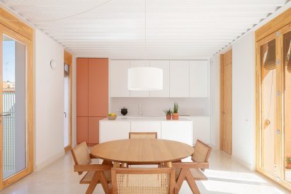 Kitchen and dining space within apartment by Be Studio