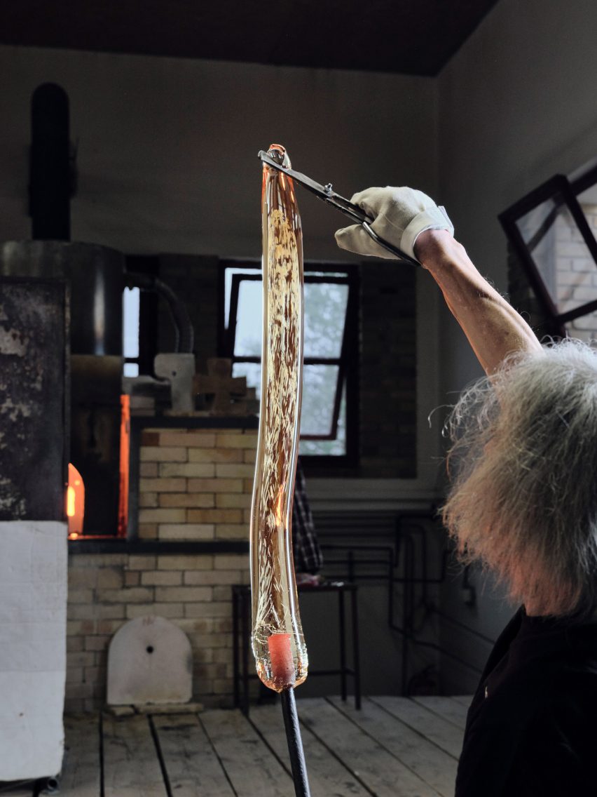 Glass blower shaping the Bomma Flare pendant lighting fixture