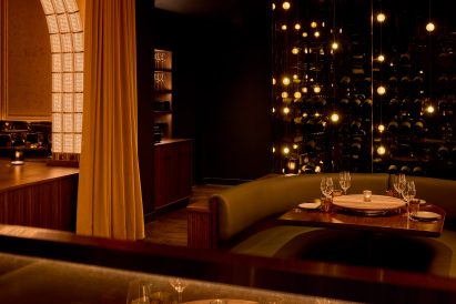 Champagne collection displayed in glass cases with bubble-like lighting