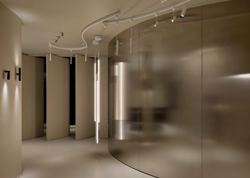 A room with a curving metal wall