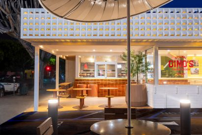 View of the outdoor dining area at Dino's Famous Chicken at night