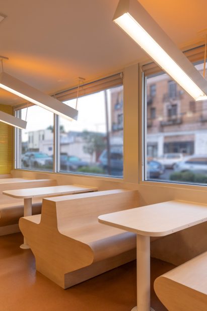 Linear light fixtures suspended over booths