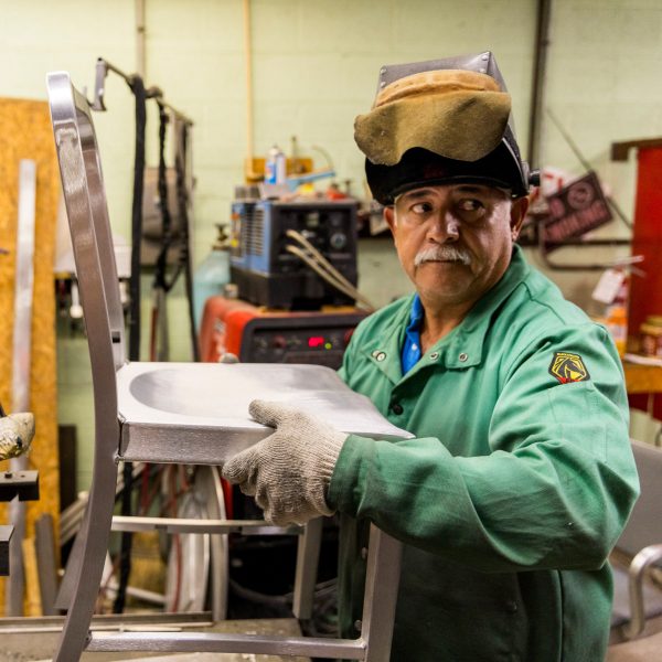 Photo of a person holding a chair prototype