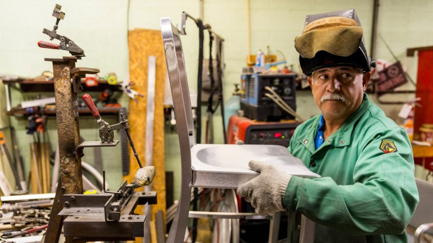 Photo of a person holding a chair prototype