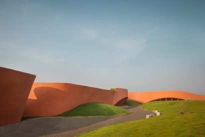 Iron oxide concrete facade of Hampi Arts Lab in India