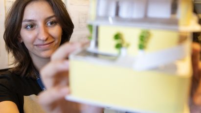 Student showing her architectural model