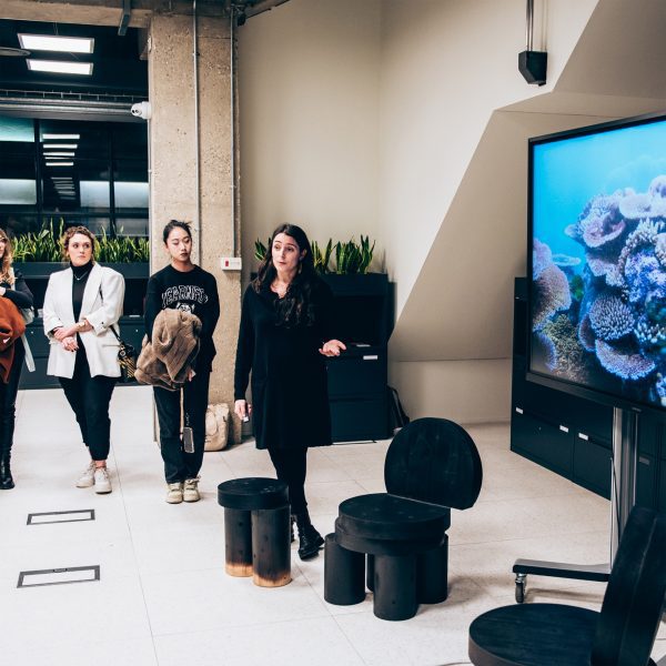 Students gathered around a screen during a presentation