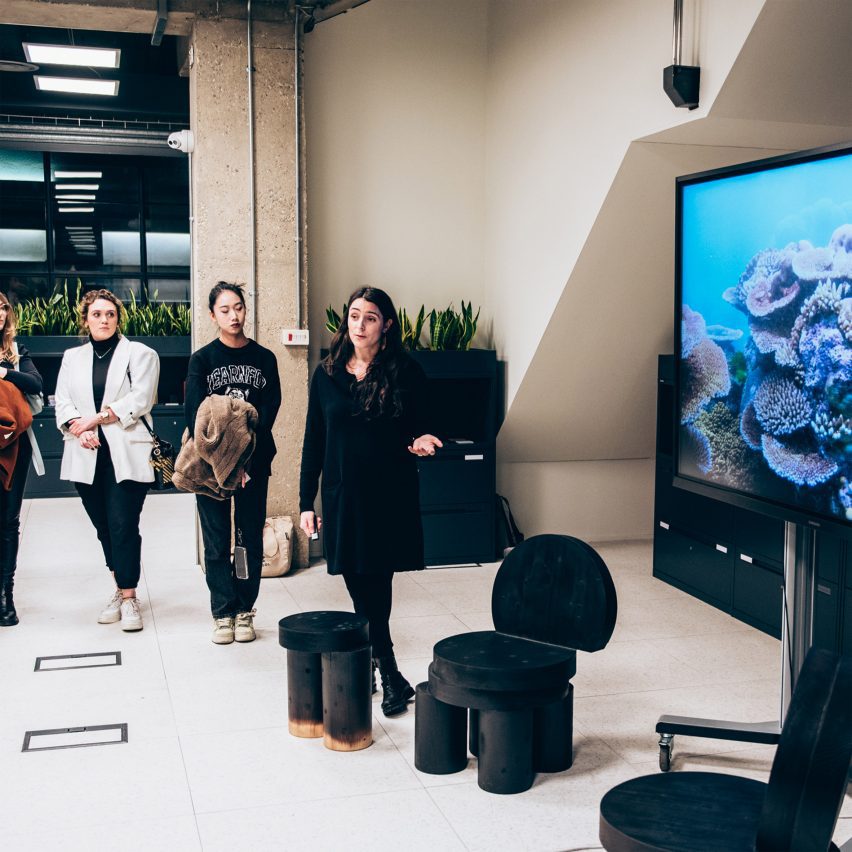 Students gathered around a screen during a presentation