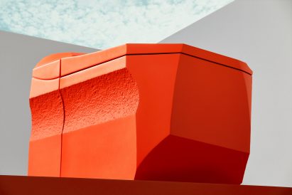 Side view of textured orange toilet