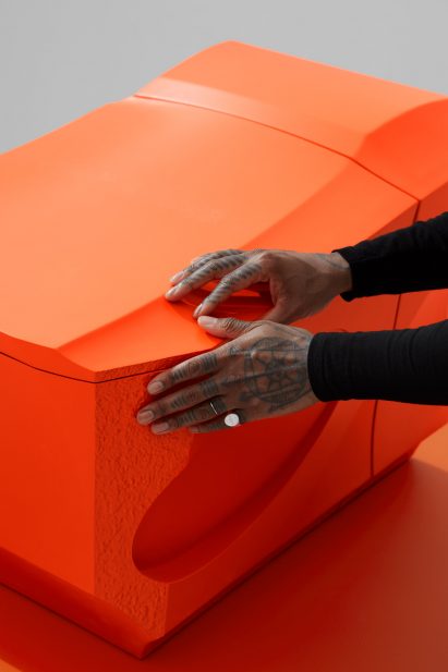 Hands on the lid of the Formation 002 toilet by Samuel Ross