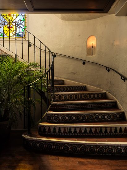 Staircase with tiled risers and iron railings 